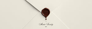 A secret envelope with aim'n stamp hiding upcoming news on a website.